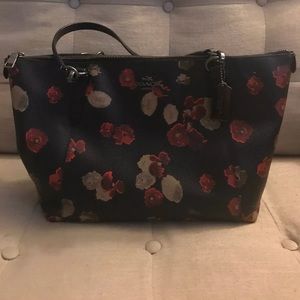 Coach leather black purse with red flowers.